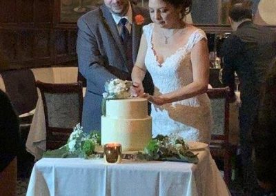 new married couple at wedding cutting cake